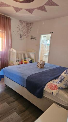 a bedroom with a bed with a crib and a window at House Nena in Bibinje
