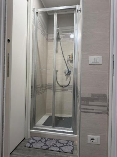 a shower with a glass door in a bathroom at Casa di Ema in Sanremo