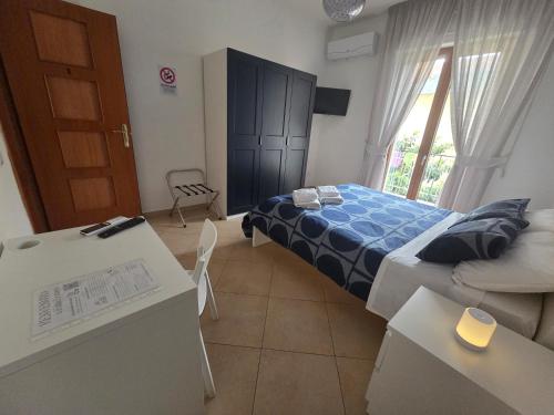 a small bedroom with a bed and a table and chairs at B&B Estia Domus in Pompei