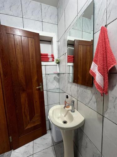 a bathroom with a sink and a mirror at Suite Familia A1 in Pomerode