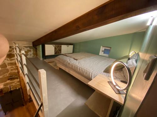 a large bed in a room with green walls at Maison de charme en pierre in Porto Ota