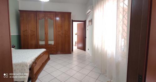 a bedroom with a bed and a door to a hallway at Casa Cesa in Selargius