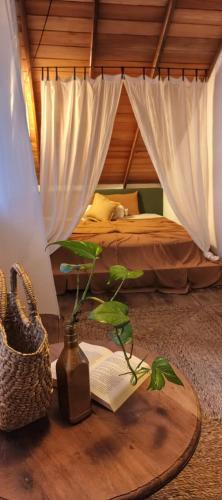 a bedroom with a bed and a table with a book at Lahima Cabanas Villa in Dickwella