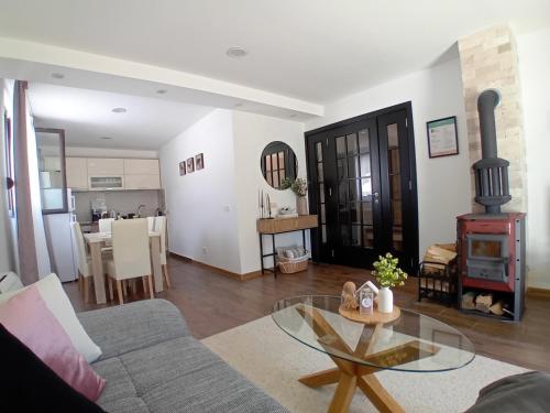 a living room with a couch and a wood stove at Durmitor Sunstone in Žabljak