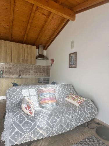 a bedroom with a bed with pillows on it at One Bedroom Chalet with private bathroom and kitchen in Alcobaça