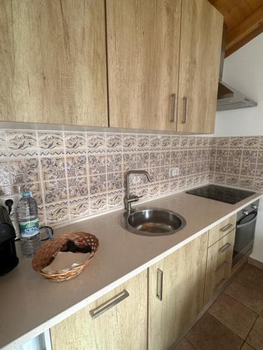 a kitchen with a sink and a counter top at One Bedroom Chalet with private bathroom and kitchen in Alcobaça