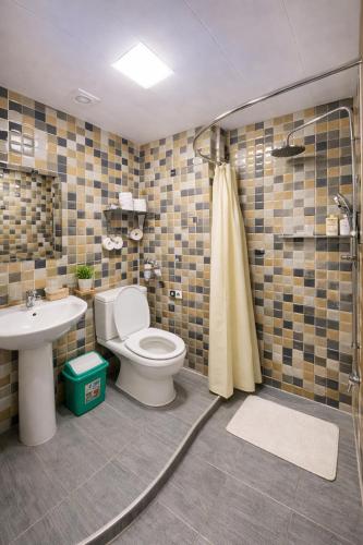 a bathroom with a toilet and a sink and a shower at Colibri Traditional Hostel in Samarkand