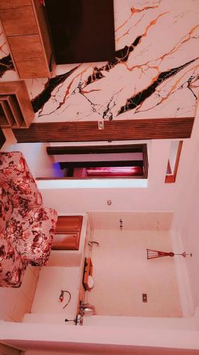 a bathroom with a sink and a marble ceiling at Taj Plaza in Sowayma