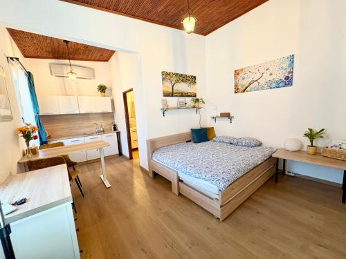 a small bedroom with a bed and a sink at Little park house with car charger in Stupava