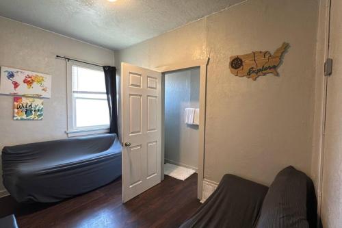a living room with a couch and a window at Value Rental no frills in Midvale