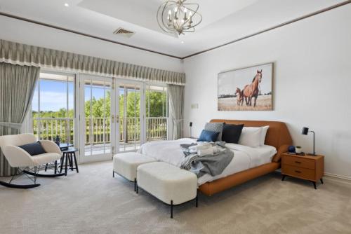 a bedroom with a bed and a large window at Peninsula Farm Stay in Somerville