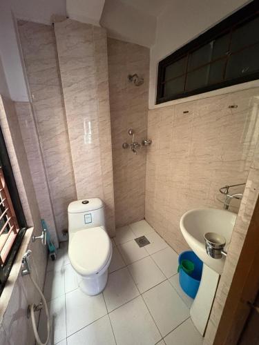 a bathroom with a toilet and a sink at Monkey Temple Homestay in Kathmandu