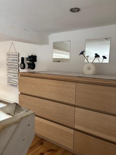 a bedroom with a dresser with two mirrors on the wall at Appartement centre de Cassis in Cassis