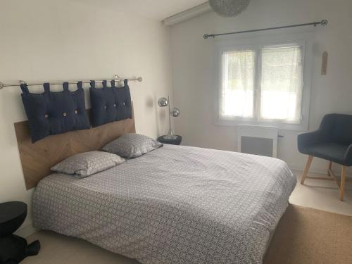 a bedroom with a large bed and a window at T2 cyclamen independent in Cholet