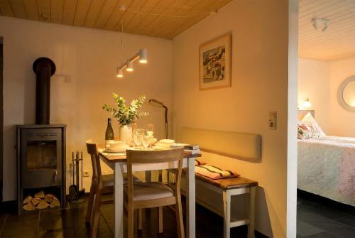 a small dining room with a table and a bed at Klaushausen Ferienoase in Überlingen