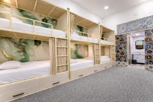a room with four bunk beds in it at Colibri Traditional Guest house in Samarkand