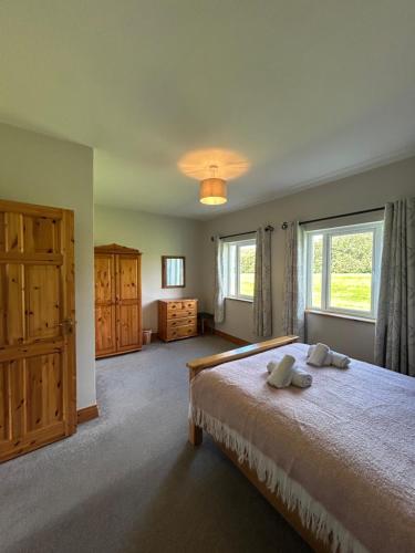 a bedroom with a bed with two towels on it at Dingle Mist in Dingle