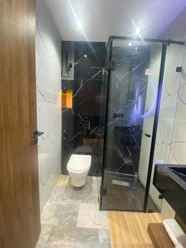 a bathroom with a toilet and a glass shower at studio neuf calme et propre in Casablanca