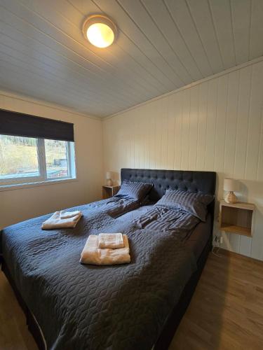 a bedroom with a large bed with two towels on it at Hardanger Granvin Living in Granvin