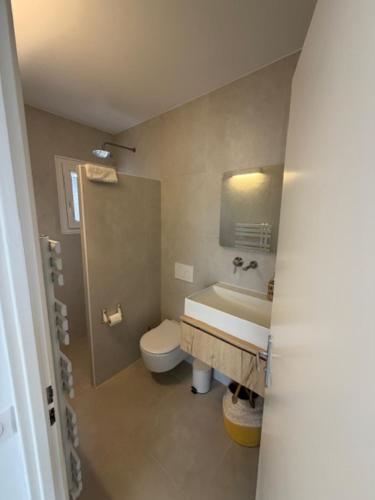 a bathroom with a sink and a toilet at Villa U Mulinu in Calvi