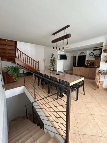 a living room with a dining table and a kitchen at Coeur Cevennes in La GrandʼCombe
