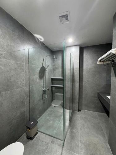 a bathroom with a glass shower and a toilet at HAHA'S Villa in Binh Hai
