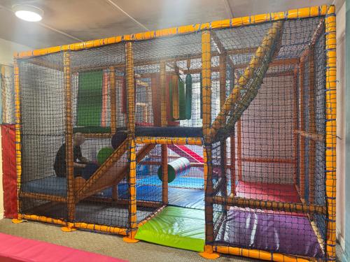 a play room with a play set with a slide at Kieras View At Bideford Bay in Bideford