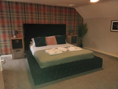 a bedroom with a bed with two towels on it at The City in Durham