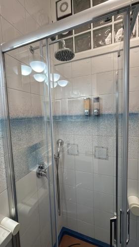 a shower with a glass door in a bathroom at Chicca House in Maiori
