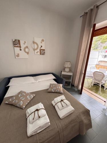 a bedroom with a bed with two towels on it at Chicca House in Maiori