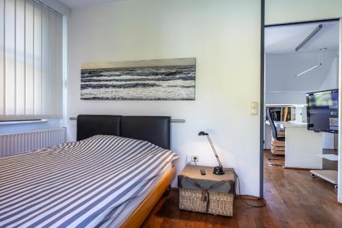 a bedroom with a bed and a television at Vacation, also with a dog, in Stade! in Stade