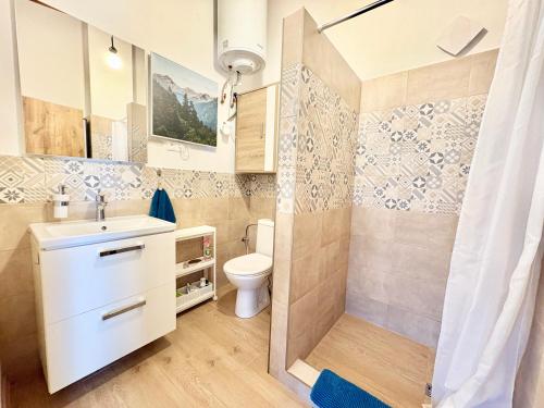a bathroom with a toilet and a sink and a shower at Little park house with car charger in Stupava