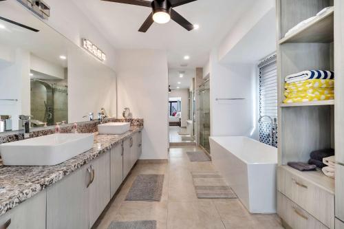 a bathroom with two sinks and a large mirror at Marbella Lane Premium Ocean View Villa & Pool in Cabo San Lucas