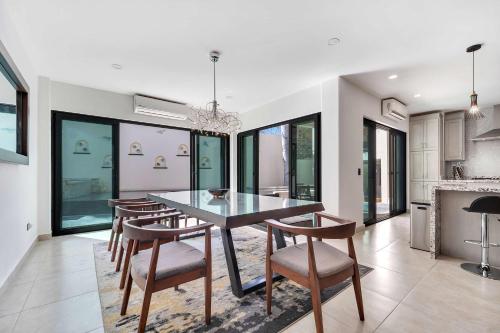 a dining room with a table and some chairs at Marbella Lane Premium Ocean View Villa & Pool in Cabo San Lucas