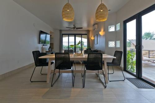 a dining room with a table and chairs at Marbella lane - Stylish Private Villa OceanViews in Cabo San Lucas