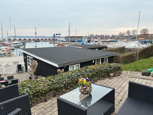 a table with a vase on it on a patio at Charming holiday home on the harbour (5 persons) in Rødvig