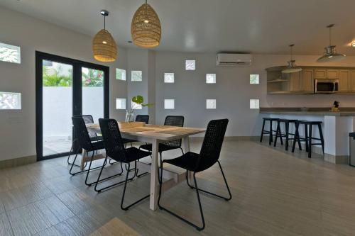 a dining room with a table and chairs at Marbella lane - Chic Casa with Amazing OceanViews in Cabo San Lucas