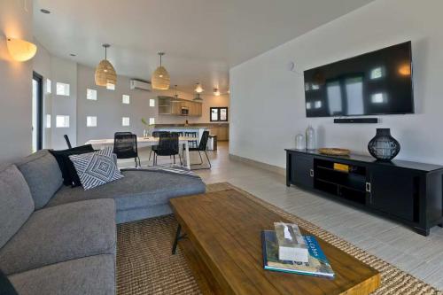a living room with a couch and a table at Marbella lane - Chic Casa with Amazing OceanViews in Cabo San Lucas