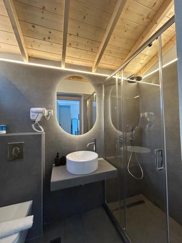 a bathroom with a sink and a shower at Beyond The Bridge in Sívros