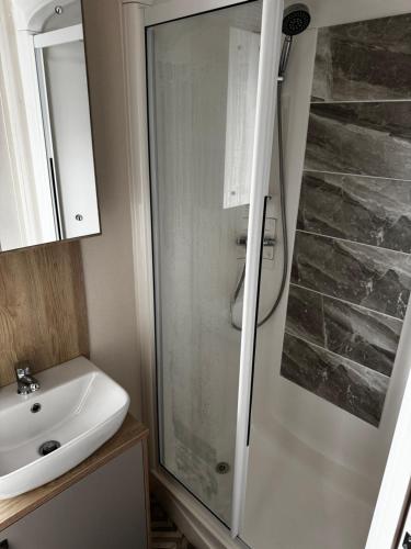 a bathroom with a shower and a sink at Tattershall Lakes 49 Larch View in Tattershall