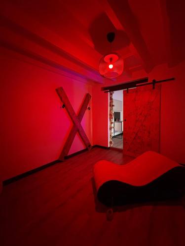 a red room with a bed and a red light at maison romantique avec spa privé in Montargis