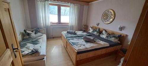 a bedroom with two beds and a window at Fewo Hereinspaziert in Schwendau