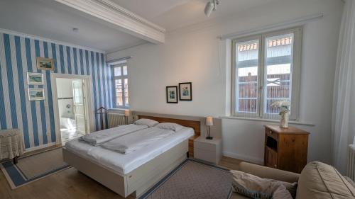 a bedroom with a bed and a couch in it at Ostsee Stadthus in Heiligenhafen