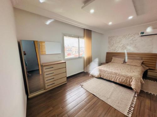 a bedroom with a bed and a dresser and a mirror at Bizerta Méditerranée in Bizerte