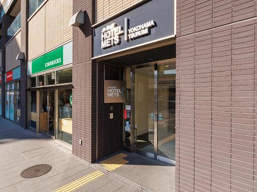 a store front with the entrance to a shopping mall at JR-East Hotel Mets Yokohama Tsurumi in Yokohama