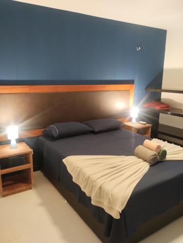 a bedroom with a large bed with two lamps at Eco Paradise 228 in Cumbuco