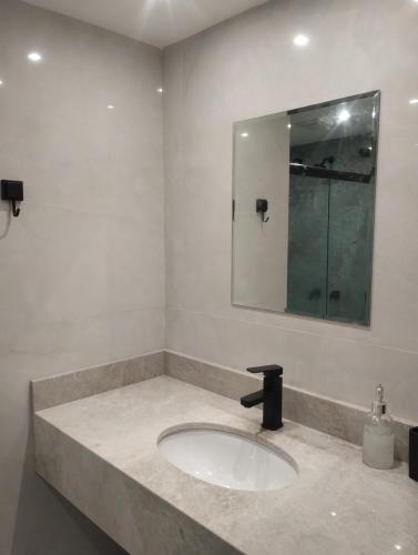 a bathroom with a sink and a mirror at Eco Paradise 228 in Cumbuco