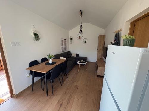 a kitchen and living room with a table and a couch at Kuća za odmor Mia in Gornja Gračenica