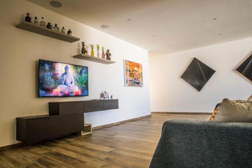 a living room with a flat screen tv on the wall at Cosy & Central Penthouse in Victoria in Victoria