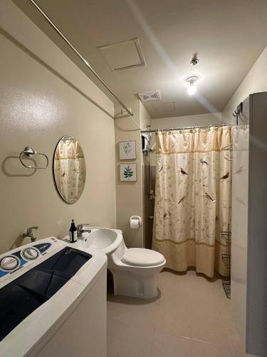 a bathroom with a toilet and a sink and a shower at Ilo2stayAirbnb 1BR 334 in Molo